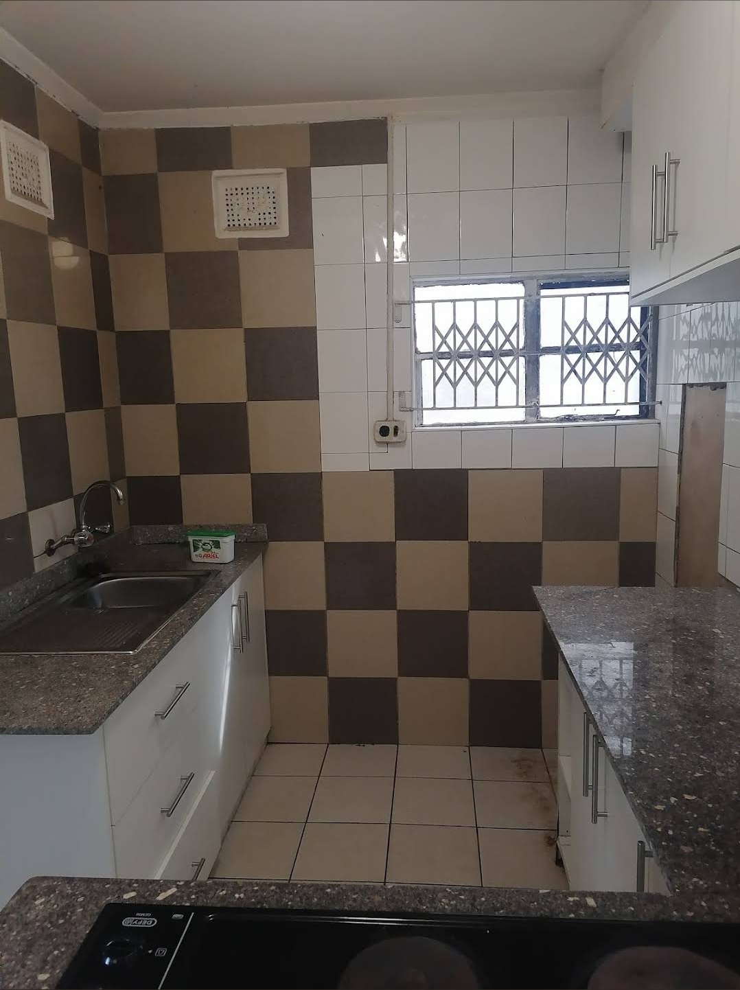 Retro-tiled kitchen with sink